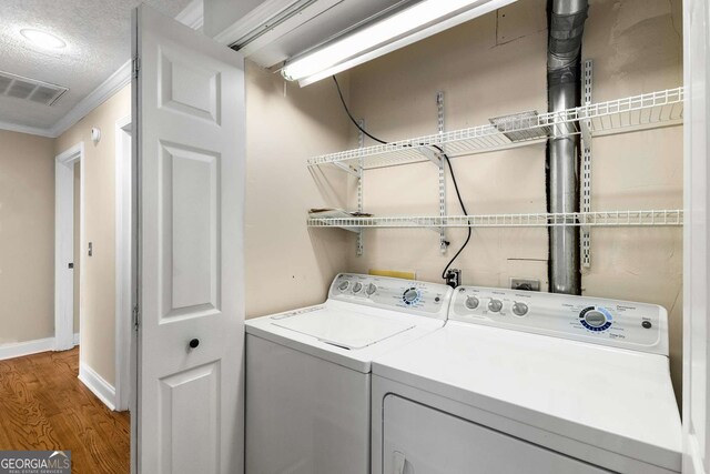 115 Biscayne Dr NW Unit E3, Atlanta, GA 30309 - laundry area with separate washer and dryer, wood finished floors, and crown molding