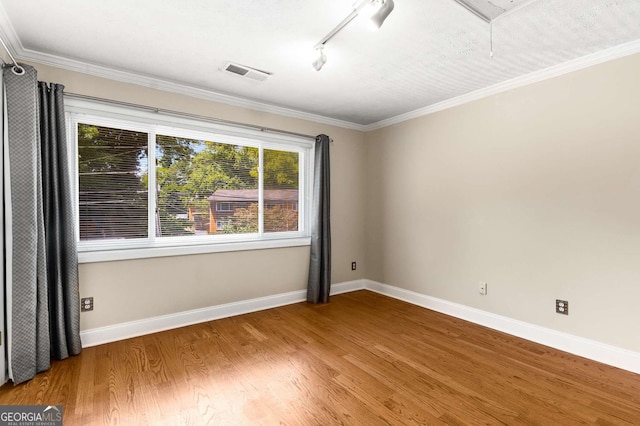 115 Biscayne Dr NW Unit E3, Atlanta, GA 30309 - empty room featuring wood finished floors, attic access, ornamental molding, and rail lighting