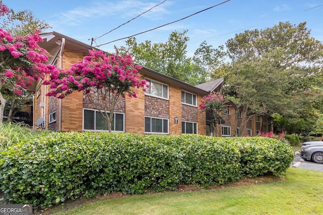 115 Biscayne Dr NW Unit E3, Atlanta, GA 30309 - view of side of home with a yard and brick siding
