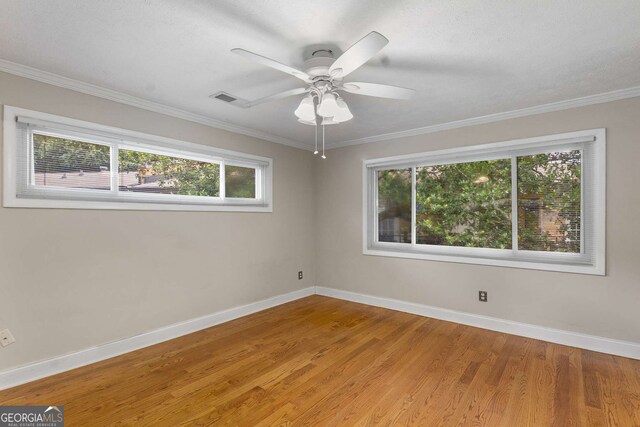 115 Biscayne Dr NW Unit E3, Atlanta, GA 30309 - unfurnished room with healthy amount of natural light, crown molding, wood finished floors, and ceiling fan