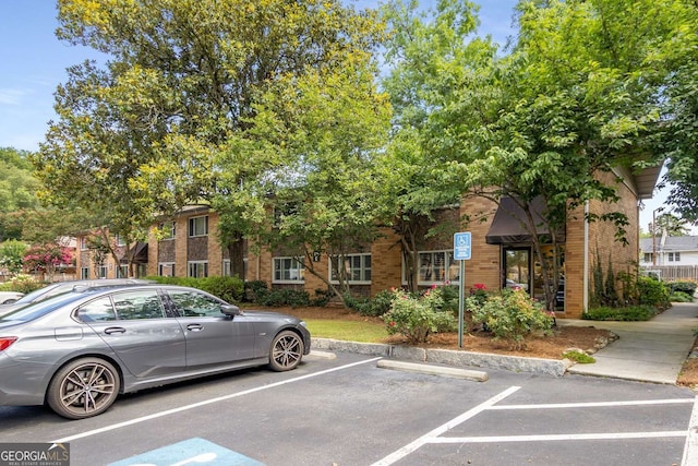 115 Biscayne Dr NW Unit E3, Atlanta, GA 30309 - view of front facade featuring brick siding and uncovered parking