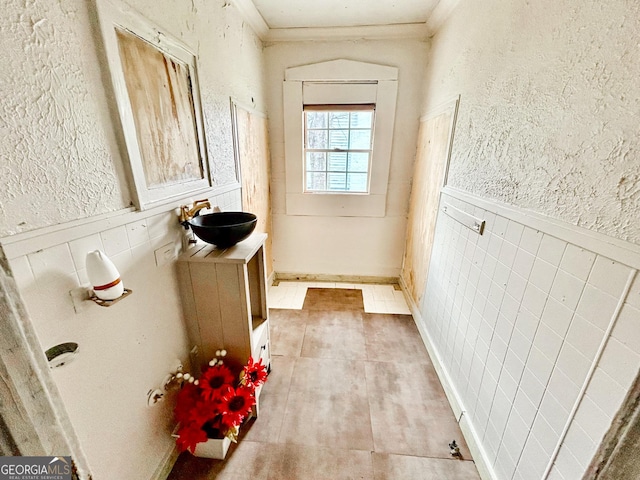 826 W Grenada Ter, Macon, GA 31206 - doorway to outside with crown molding, a wainscoted wall, and a textured wall