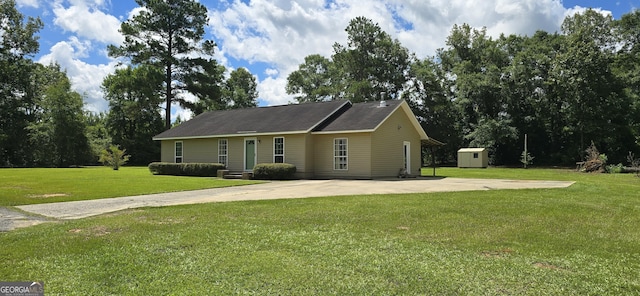 467 Witherington Cir, East Dublin, GA 31027 - ranch-style house featuring a storage unit and a front yard