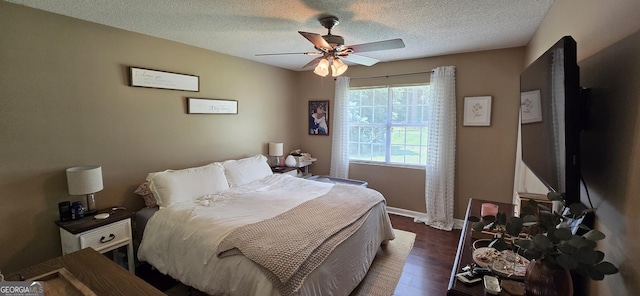 467 Witherington Cir, East Dublin, GA 31027 - bedroom with dark wood-type flooring, a textured ceiling, and ceiling fan