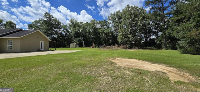 467 Witherington Cir, East Dublin, GA 31027 - view of green lawn featuring a storage shed and a patio