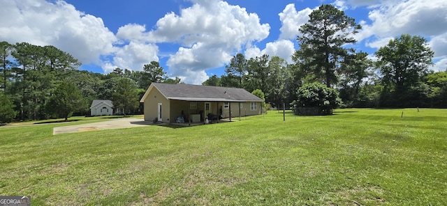 467 Witherington Cir, East Dublin, GA 31027 - view of green lawn with a patio area and view of wooded area