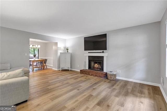 410 Sheringham Ct, Roswell, GA 30076 - living area featuring a chandelier, light wood-type flooring, and a brick fireplace
