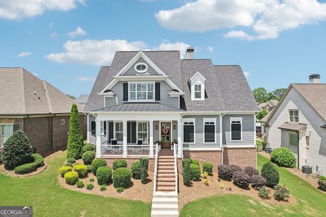 2470 Green Mountain Dr, Braselton, GA 30517 - view of front of house featuring covered porch, a front yard, a shingled roof, and a standing seam roof