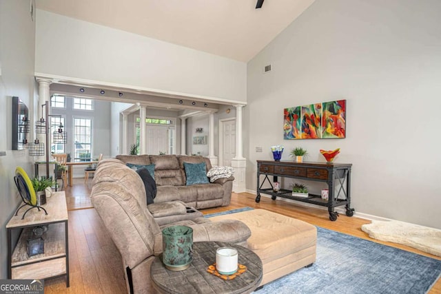 1511 Rocky Knoll Ln, Dacula, GA 30019 - living room featuring ornate columns, high vaulted ceiling, and wood finished floors