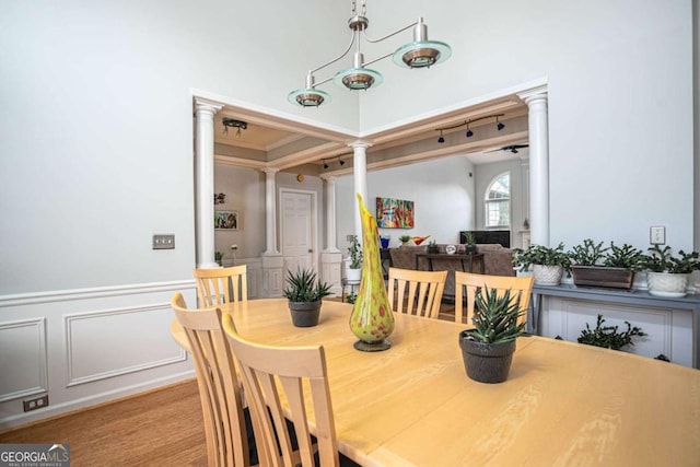 1511 Rocky Knoll Ln, Dacula, GA 30019 - dining room featuring ornate columns, a decorative wall, wainscoting, and ornamental molding
