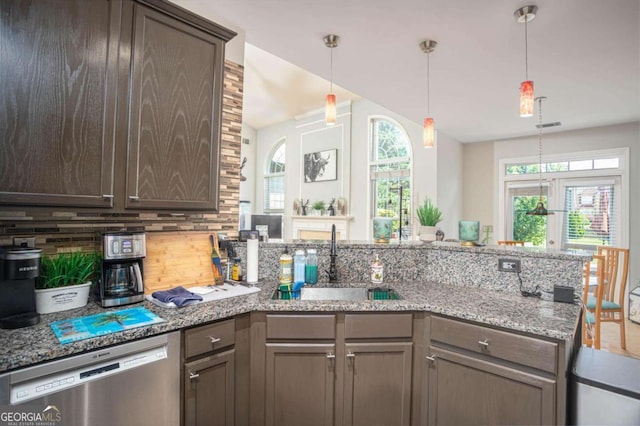 1511 Rocky Knoll Ln, Dacula, GA 30019 - kitchen with stainless steel dishwasher, a peninsula, tasteful backsplash, light stone counters, and dark brown cabinetry