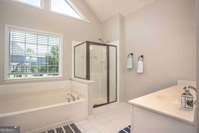 1511 Rocky Knoll Ln, Dacula, GA 30019 - bathroom featuring tile patterned flooring, a bath, a shower stall, vanity, and vaulted ceiling