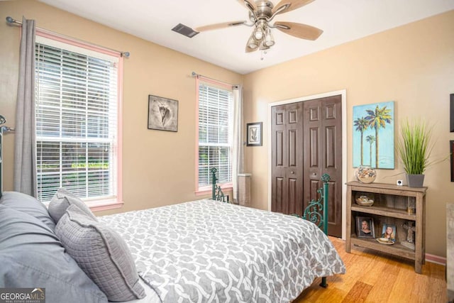 1511 Rocky Knoll Ln, Dacula, GA 30019 - bedroom with light wood-style flooring, a closet, and ceiling fan