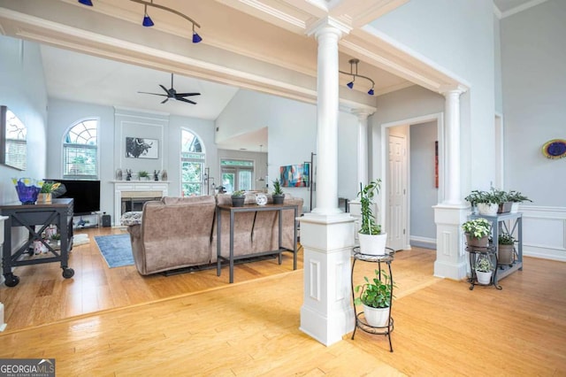 1511 Rocky Knoll Ln, Dacula, GA 30019 - living area featuring decorative columns, ceiling fan, lofted ceiling, a fireplace, and ornamental molding