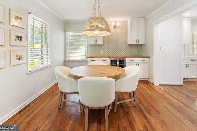 2163 Medfield Trl NE, Chamblee, GA 30345 - dining area featuring wine cooler, light wood-type flooring, and ornamental molding