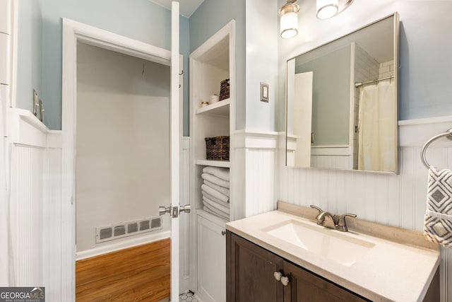 2163 Medfield Trl NE, Chamblee, GA 30345 - full bath with vanity, wainscoting, and wood finished floors