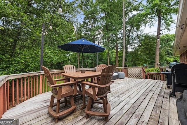 2163 Medfield Trl NE, Chamblee, GA 30345 - deck with outdoor dining space, a grill, and view of wooded area