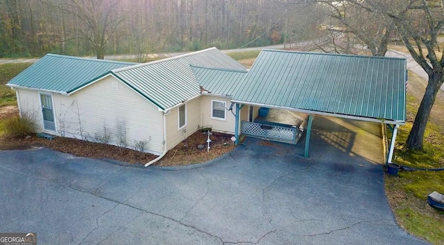 56 Harry Pauls Rd, Danielsville, GA 30633 - view of front facade featuring a metal roof, asphalt driveway, and an attached carport