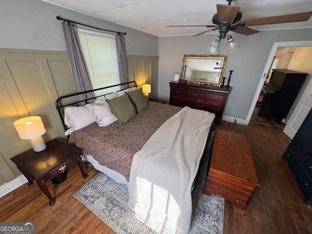 56 Harry Pauls Rd, Danielsville, GA 30633 - bedroom featuring wood finished floors, a decorative wall, ceiling fan, and a wainscoted wall