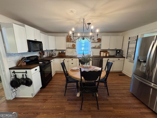 56 Harry Pauls Rd, Danielsville, GA 30633 - kitchen with black appliances, open shelves, dark countertops, a chandelier, and white cabinets