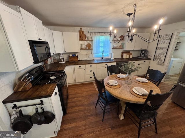 56 Harry Pauls Rd, Danielsville, GA 30633 - kitchen featuring black appliances, open shelves, a chandelier, dark wood finished floors, and butcher block counters