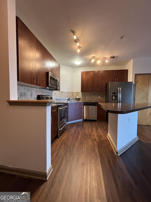 898 Oak St SW Unit 1215, Atlanta, GA 30310 - kitchen featuring stainless steel appliances, dark wood finished floors, backsplash, dark countertops, and dark brown cabinetry
