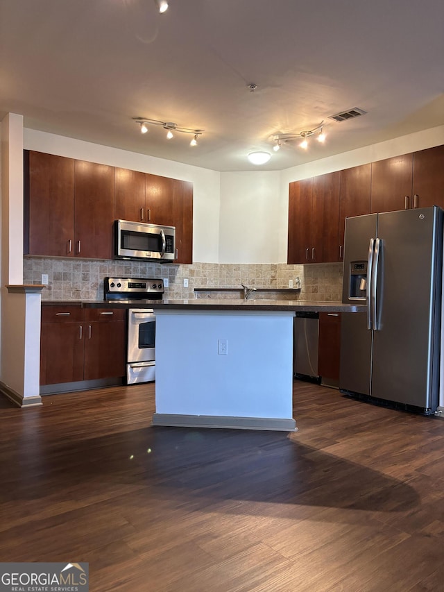 898 Oak St SW Unit 1215, Atlanta, GA 30310 - kitchen with stainless steel appliances, dark countertops, dark wood-style floors, and tasteful backsplash