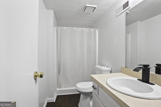 1271 Muirforest Ln, Stone Mountain, GA 30088 - bathroom with wood finished floors, vanity, a textured ceiling, and a shower stall