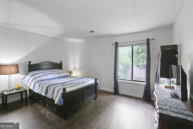 1271 Muirforest Ln, Stone Mountain, GA 30088 - bedroom featuring wood finished floors and a textured ceiling
