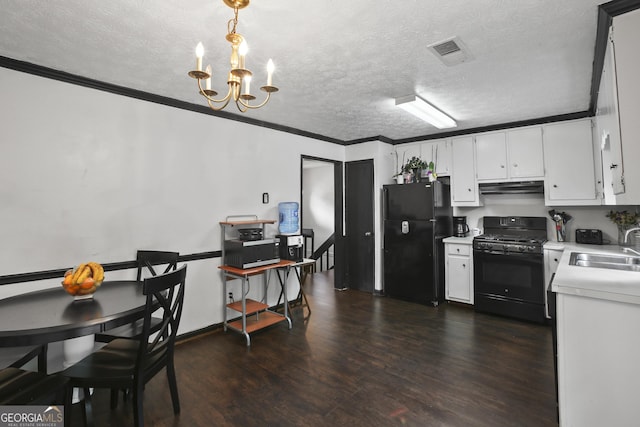 1271 Muirforest Ln, Stone Mountain, GA 30088 - kitchen with black appliances, under cabinet range hood, light countertops, a chandelier, and a textured ceiling