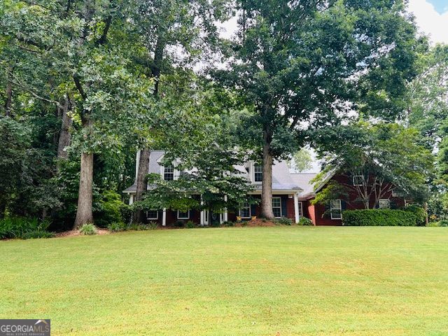 149 Crown Oaks Dr, Stockbridge, GA 30281 - obstructed view of property featuring a front lawn