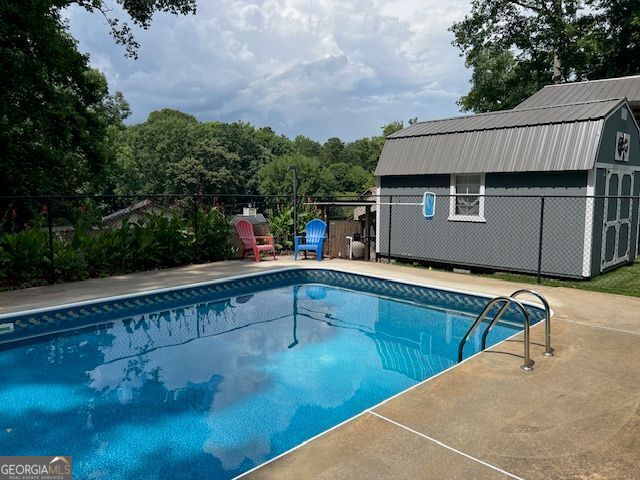 149 Crown Oaks Dr, Stockbridge, GA 30281 - view of pool with an outdoor structure and a patio