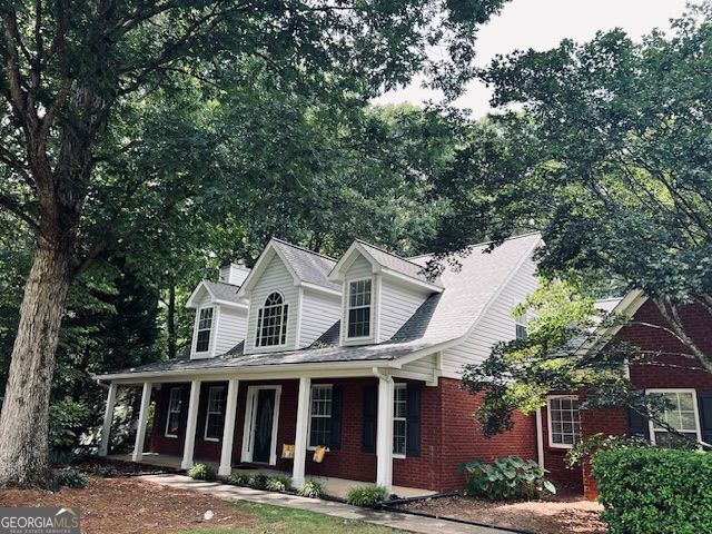 149 Crown Oaks Dr, Stockbridge, GA 30281 - cape cod house with covered porch and brick siding