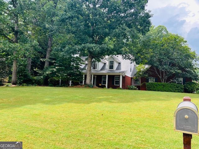 149 Crown Oaks Dr, Stockbridge, GA 30281 - new england style home featuring a front yard