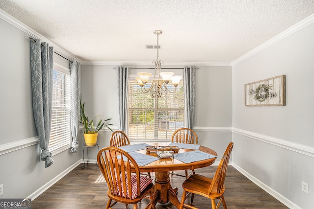 149 Crown Oaks Dr, Stockbridge, GA 30281 - dining space featuring a chandelier, a textured ceiling, dark wood finished floors, and ornamental molding