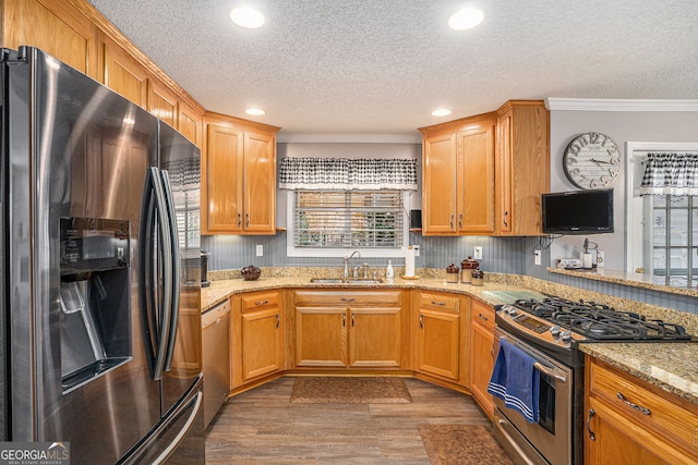 149 Crown Oaks Dr, Stockbridge, GA 30281 - kitchen featuring appliances with stainless steel finishes, a textured ceiling, ornamental molding, light stone countertops, and recessed lighting