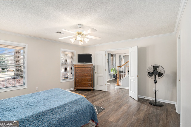 149 Crown Oaks Dr, Stockbridge, GA 30281 - bedroom featuring dark wood finished floors, a textured ceiling, multiple windows, ornamental molding, and a ceiling fan