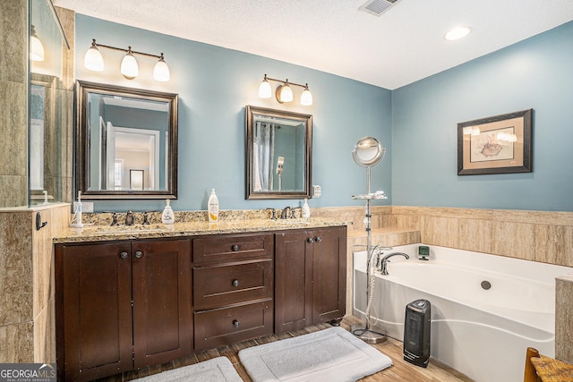 149 Crown Oaks Dr, Stockbridge, GA 30281 - full bathroom with a garden tub, wood finished floors, and double vanity
