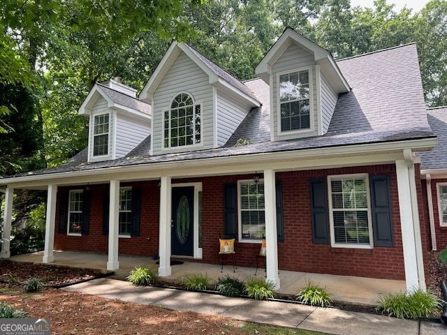 149 Crown Oaks Dr, Stockbridge, GA 30281 - view of front of home featuring covered porch, brick siding, and a shingled roof