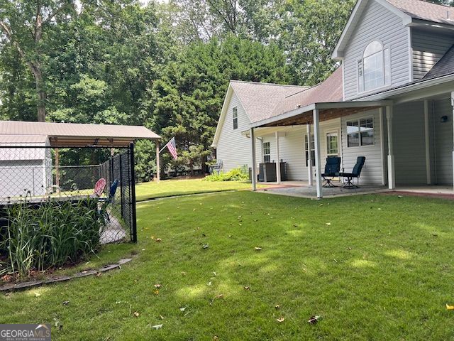 149 Crown Oaks Dr, Stockbridge, GA 30281 - view of grassy yard featuring a patio
