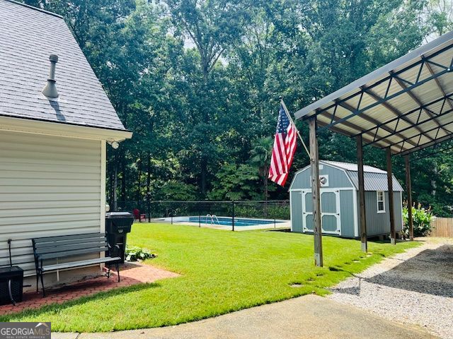 149 Crown Oaks Dr, Stockbridge, GA 30281 - view of yard with a storage shed and view of scattered trees