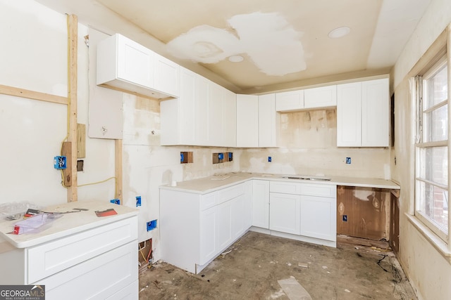 2522 Frost Dr SW, Marietta, GA 30008 - kitchen with electric cooktop, white cabinets, decorative backsplash, and light countertops