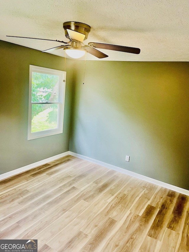 935 Mccall Rd, Macon, GA 31217 - empty room with a ceiling fan, light wood finished floors, and a textured ceiling