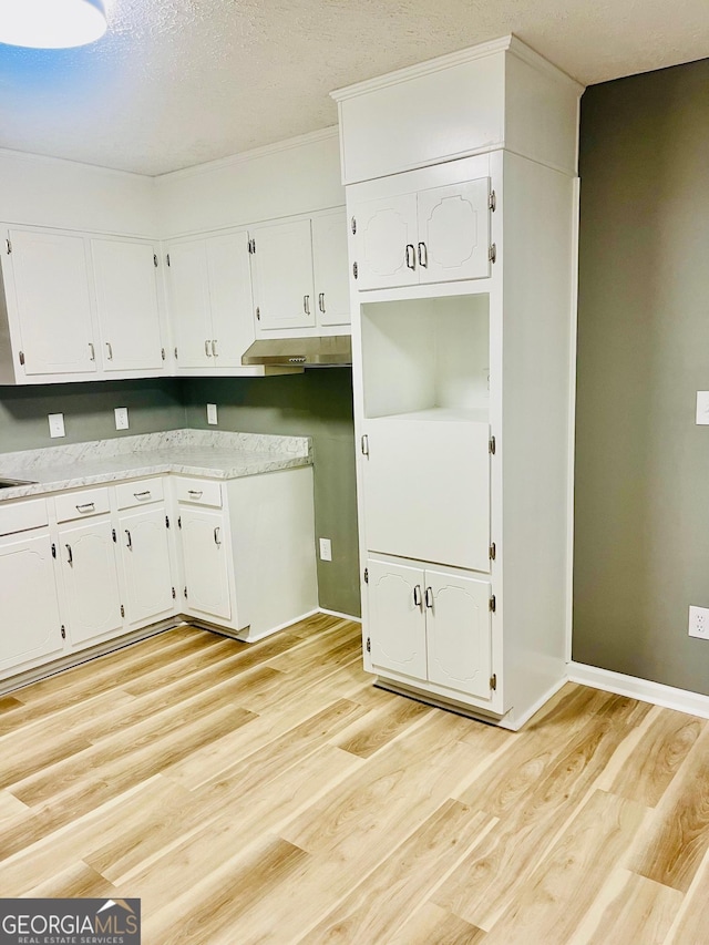 935 Mccall Rd, Macon, GA 31217 - kitchen featuring white cabinets, light wood-type flooring, light countertops, and a textured ceiling