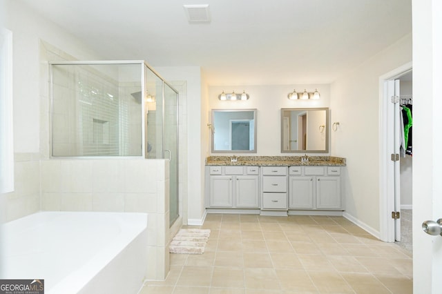 232 Shelton Cir, Temple, GA 30179 - full bath with a stall shower, double vanity, a garden tub, and tile patterned flooring
