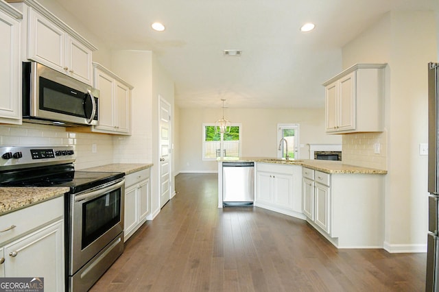 232 Shelton Cir, Temple, GA 30179 - kitchen with stainless steel appliances, a peninsula, tasteful backsplash, dark wood-style floors, and recessed lighting