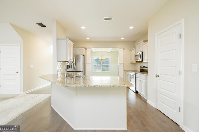 232 Shelton Cir, Temple, GA 30179 - kitchen with stainless steel appliances, backsplash, wood finished floors, light stone counters, and recessed lighting