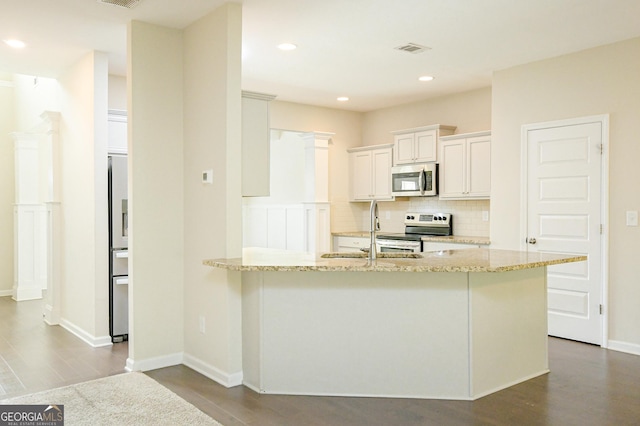 232 Shelton Cir, Temple, GA 30179 - kitchen with stainless steel appliances, dark wood-style floors, light stone counters, decorative backsplash, and recessed lighting