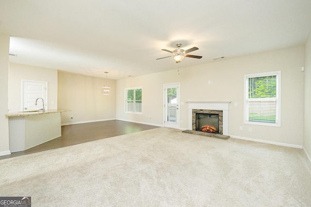 232 Shelton Cir, Temple, GA 30179 - unfurnished living room featuring ceiling fan, healthy amount of natural light, a fireplace, and carpet flooring