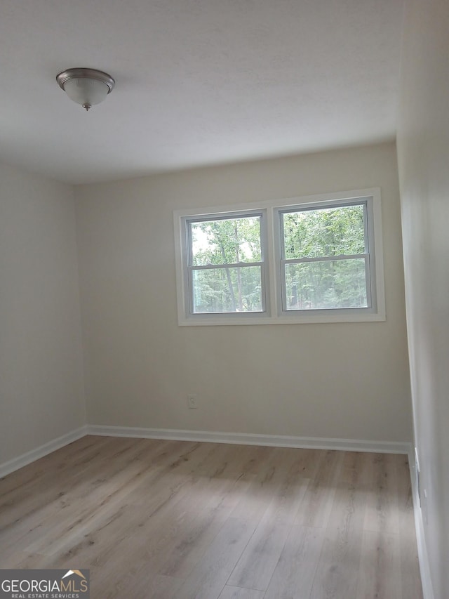 6985 Butner Rd, South Fulton, GA 30349 - unfurnished room featuring plenty of natural light and light wood finished floors
